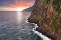 Madeira island - Dramatic sunrise over atlantic ocean with waterfall landscape from Miradouro do Veu da Noiva