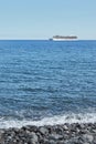Cruise ship passing by coastline , man Stand Up Paddling