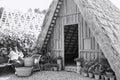 Madeira, Portugal: an isolated woman is doing housework in the garden of her traditional house with a thatched roof Royalty Free Stock Photo