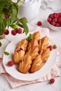 Madeleine cookies with raspberries. Traditional French biscuits in a shape of seashells.