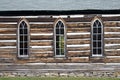 Side view of the detail of the weathered wooden log cabin church