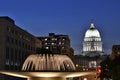 . Madison, Wisconsin, USA. Night scene with capital building and illuminated fountain in the foreground.