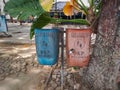 Madiun, East Java, Indonesia - September 23, 2022: Group of Plastic Waste Bins with Different Types of Waste Separation to reduce