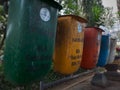 Madiun, East Java, Indonesia - September 23, 2022: Group of Plastic Waste Bins with Different Types of Waste Separation to reduce