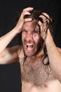 Madman pulling long hair Royalty Free Stock Photo