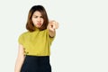 Madness Asian woman with angry face pointing finger at camera standing over gray background