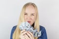 Close-up of a girl sniffing money. Madness and greed from currency. The concept of corruption and getting money at any cost.