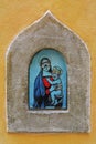 The Madonna and Child in diving masks - modern street art in medieval wine portal Buchette del vino