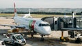 Portuguese airliner Tap with boarding bridge while maintainance crew doing checks