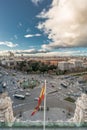 Madrid skyline cloudy sunset view from Cibeles Palace Townhall, big spanish flag Madrid City Council building