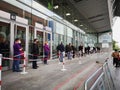 Mature people patients wearing face protective masks waiting in queue for vaccination against covid