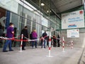 Mature people patients wearing face protective masks waiting in queue for vaccination against covid