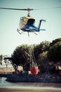 MADRID, SPAIN - AUGUST 3 : Fire rescue heavy helicopter with water bucket, goes to a fire in Madrid on August 3, 2013, Spain. Royalty Free Stock Photo