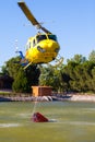 MADRID, SPAIN - AUGUST 3 : Fire rescue heavy helicopter with water bucket, goes to a fire in Madrid on August 3, 2013, Spain. Royalty Free Stock Photo