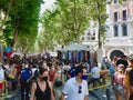 Crowd of people in protective masks walking on open air Sunday flea market downtown in La Latina Royalty Free Stock Photo