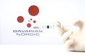 Hand holding syringe and Bavarian Nordic logo in the background