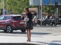 Stylish girl waiting to cross the street