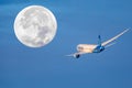 Madrid, Spain- December 20, 2022: Air Europa company plane in full flight in front of the full moon. Royalty Free Stock Photo