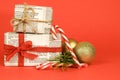 Gifts wrapped in old newspaper on red background