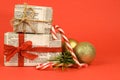 Gifts wrapped in old newspaper on red background