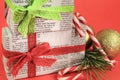 Gifts wrapped in old newspaper on red background
