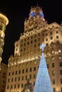 Telefonica building of Madrid with a christmas tree in foreground.