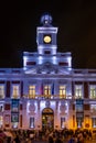 Facade of the royal post house in Plaza Sol with a crowd in front and Christmas lighting