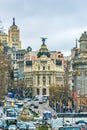 Madrid, Spain - February 13, 2014: Cars passing on the Gran Via, just before the famous Metropolis building. In Metropolis was bu Royalty Free Stock Photo