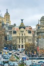 Madrid, Spain - February 13, 2014: Cars passing on the Gran Via, just before the famous Metropolis building. In Metropolis was bu