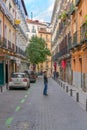 Tourists walking through the streets of the beautiful and pretty district in Madrid in a sunny day of Spring Shortly before a viru