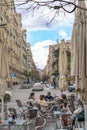 Tourists walking through the streets of the beautiful and pretty district in Madrid in a sunny day of Spring Shortly before a viru