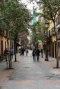 Tourists walking through the streets of the beautiful and pretty district in Madrid in a sunny day of Spring Shortly before a viru