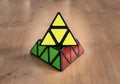 Madrid, Spain; 8 february 2019: Rubik pyramidal cube solved in a wood table Royalty Free Stock Photo