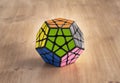 Madrid, Spain; 8 february 2019: Rubik twelve sides cube solved in a wood table Royalty Free Stock Photo