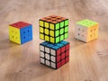 Madrid, Spain; 9 february 2019: Several Rubik cubes intelligence toys solved, in a wood table
