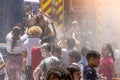 Madrid,Spain,25292022: firefighters throwing water at children in summer on the street at a local festival