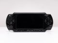 Front view of the famous Sony PSP Playstation Portable video game console in black on a white background