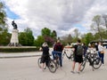 Madrid, Spain, 12.04.2022. Group of cyclists stopping in front of the Fountain of the Fallen Angel in Retiro Park.