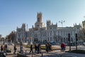 MADRID, SPAIN. JAN 2020: Tourists walking by crosswalk in front of Plaza de la Cibeles, Madrid Royalty Free Stock Photo