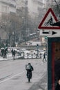 Madrid Spain - January 2021: Deliveroo rider in Alacala street with hevy snow due to Filomena Storm