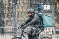 Madrid Spain - January 2021: Deliveroo rider in Alacala street with hevy snow due to Filomena Storm. From