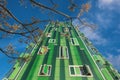 Detail of the facade of a green modern residential building in Vallecas district, in Madrid.