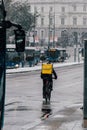 Madrid Spain - January 2021: Glovo rider in Alacala street with hevy snow due to Filomena Storm. Rider on