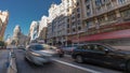 Motion blurred cars and people at Plaza de Callao subway station and Gran Via downtown Madrid