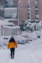 Madrid Spain - January 2021: a person with skis and a sled in a street in the capital of Spain with heavy snow due to Filomena