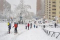 MADRID, SPAIN - JANUARY 9, 2021. Sheltered people walking on the snow-filled road.