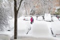 MADRID, SPAIN - JANUARY 9, 2021. Sheltered people walking on the snow-filled road.