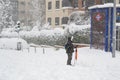 MADRID, SPAIN - JANUARY 9, 2021. Sheltered people walking on the snow-filled road.