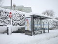 Snowstorm, blizzard on streets, bus stops covered. Snowing in winter Royalty Free Stock Photo