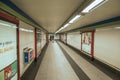 Advertising and people in passageway at the Madrid Subway